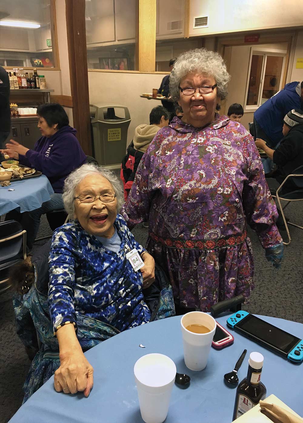 Nuiqsut elders Alice Ipalook (left) and Virgie Kasak attend Sunday dinner at the Alpine Central Facility dining room. 