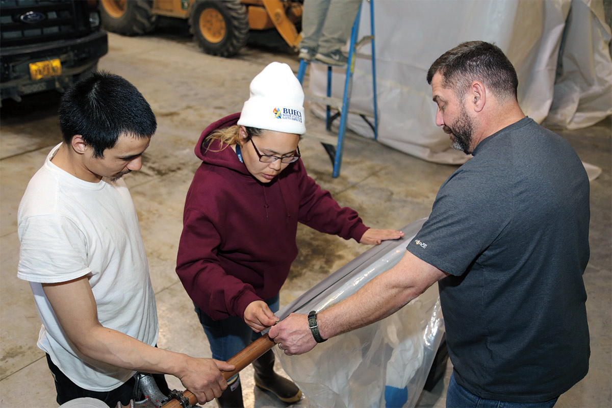Students set up containment bags while earning their Asbestos Worker Certification at Ilisaġvik College.