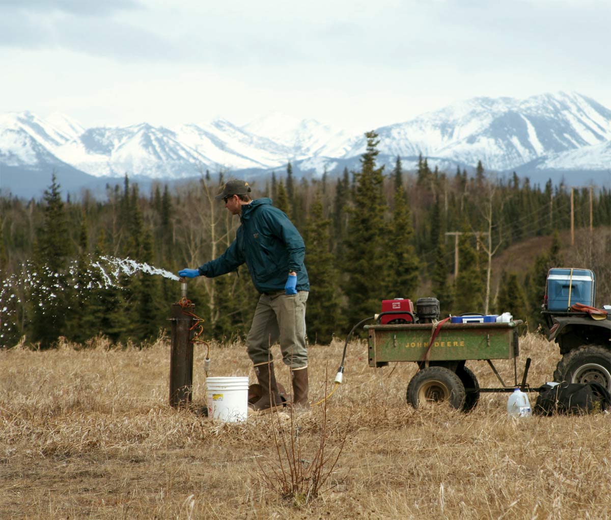 A worker conducts groundwater sampling in Kenai. 