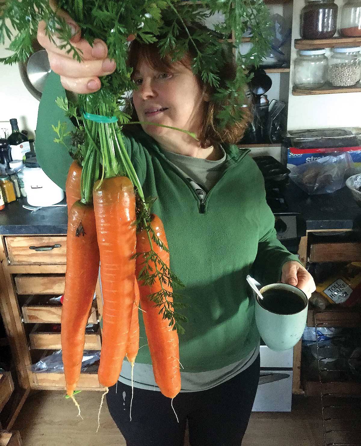 Lisa Meyers holding a bunch of carrots