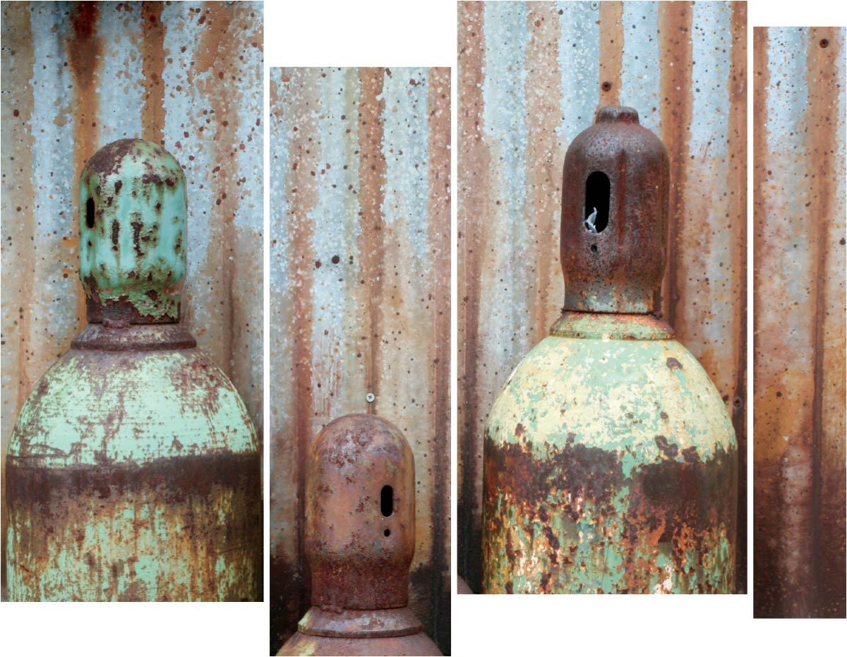 Three corroded metal containers
