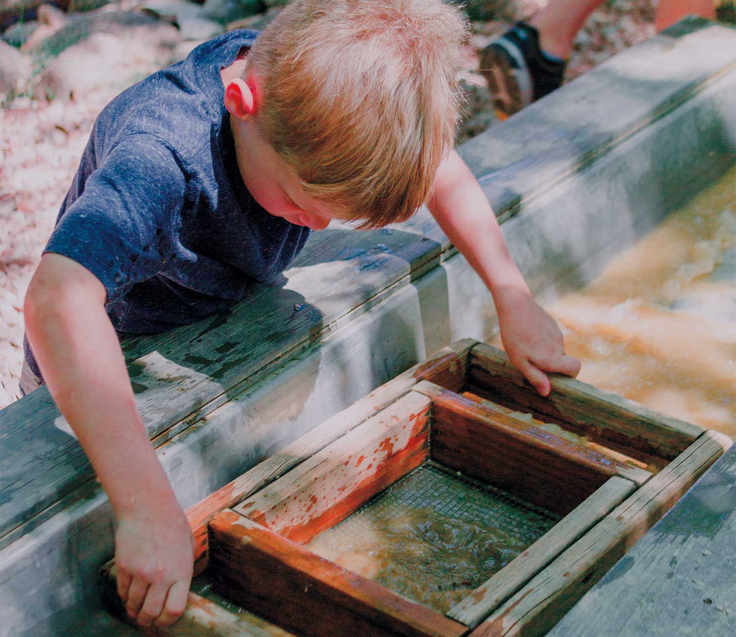 Young boy mining for gold