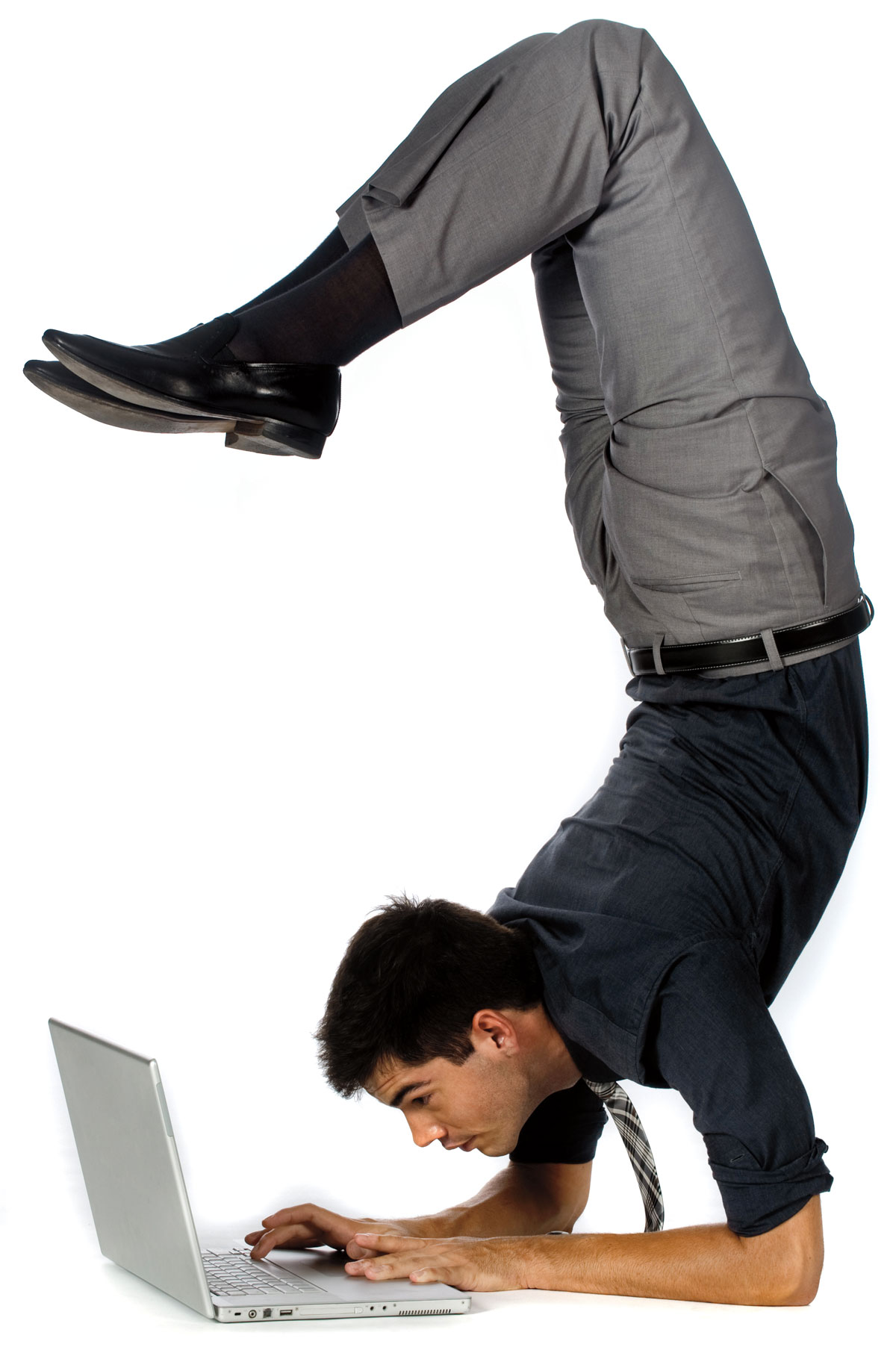 Man doing handstand while using computer