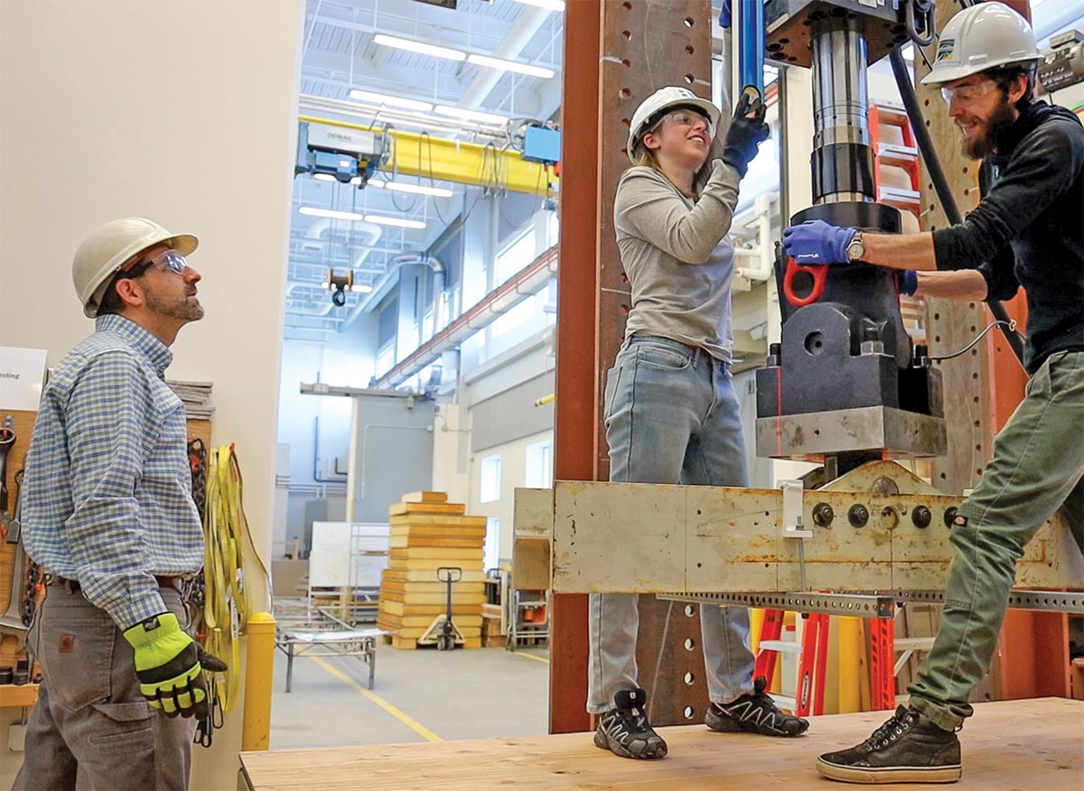 Students Jasmine Langmann and John Morton prepare equipment under the supervision of Dr. Scott Hamel