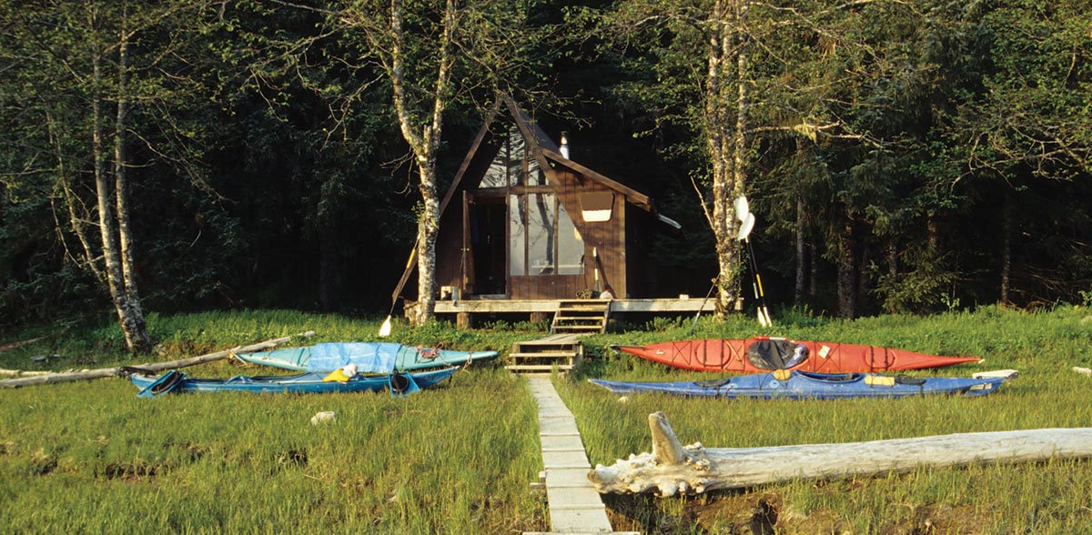 View of cabin with kayaks sitting in front