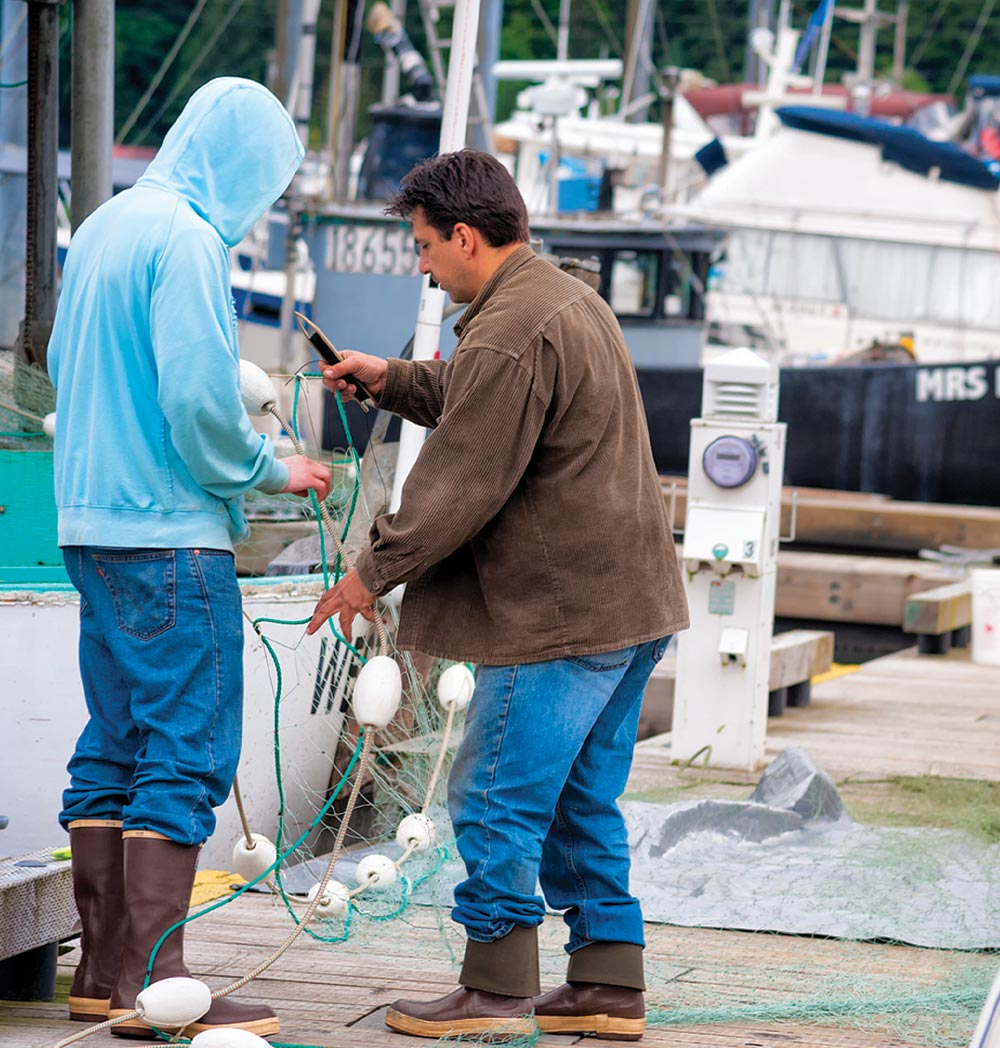 Two fishermen work on a net in Juneau