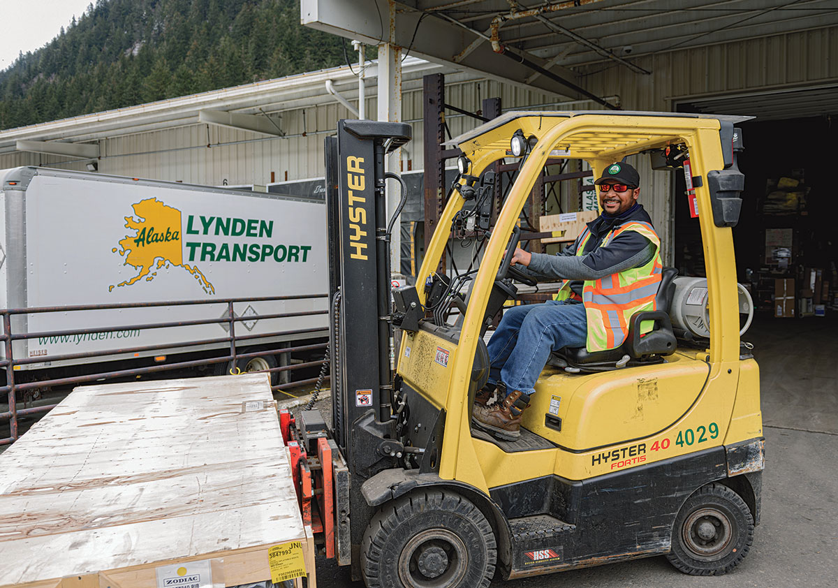 Smiling Lynden employee working on a forklift