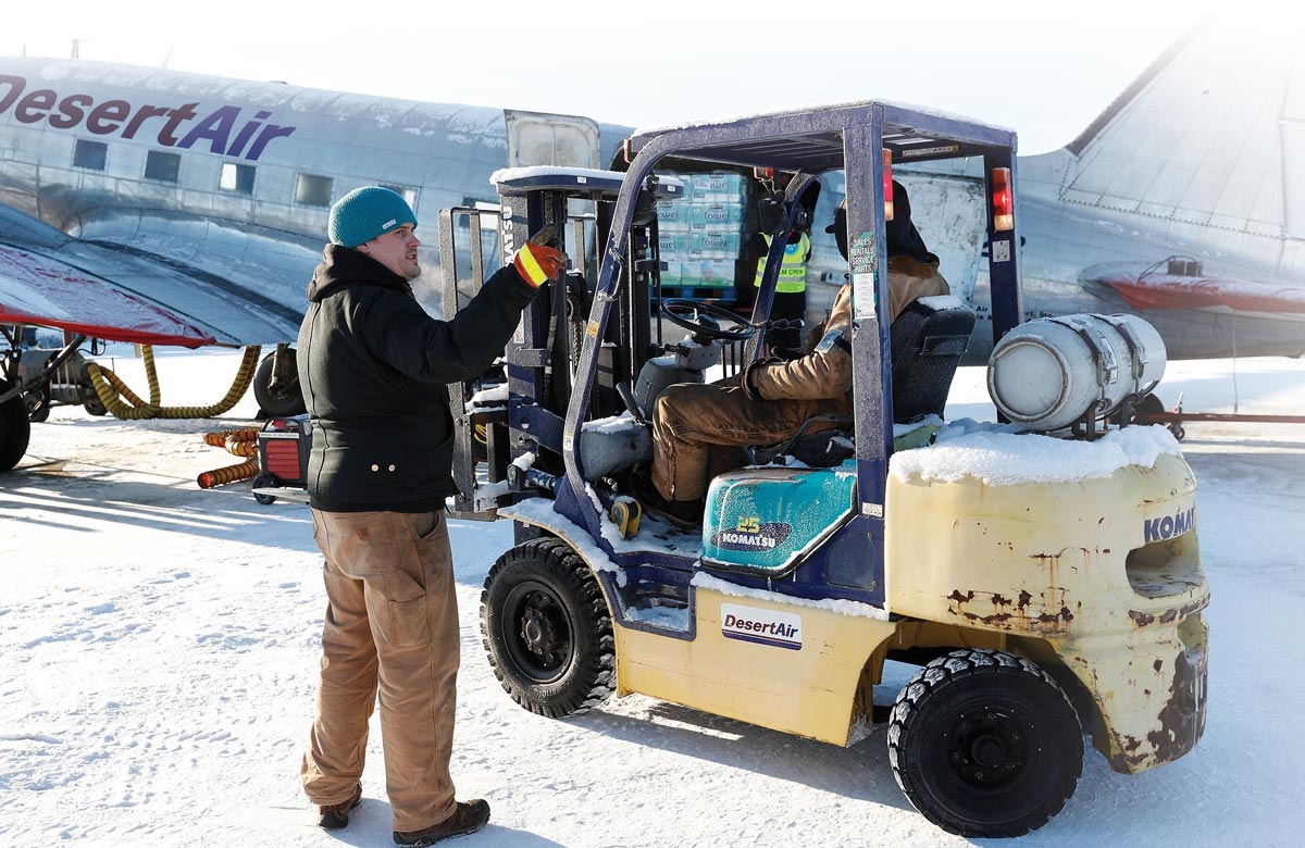 loading a plane with supplies in the snow