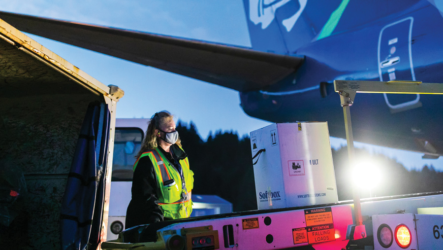 Alaska Airlines employee unloading vaccine