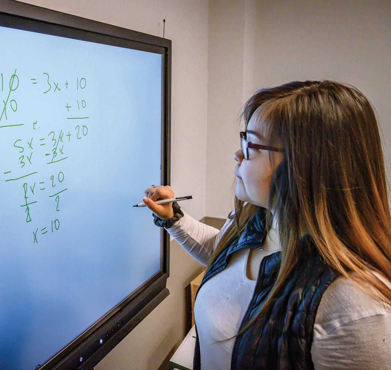 A student at the Kusilvak Career Academy uses technology in the form of an electronic whiteboard to facilitate learning