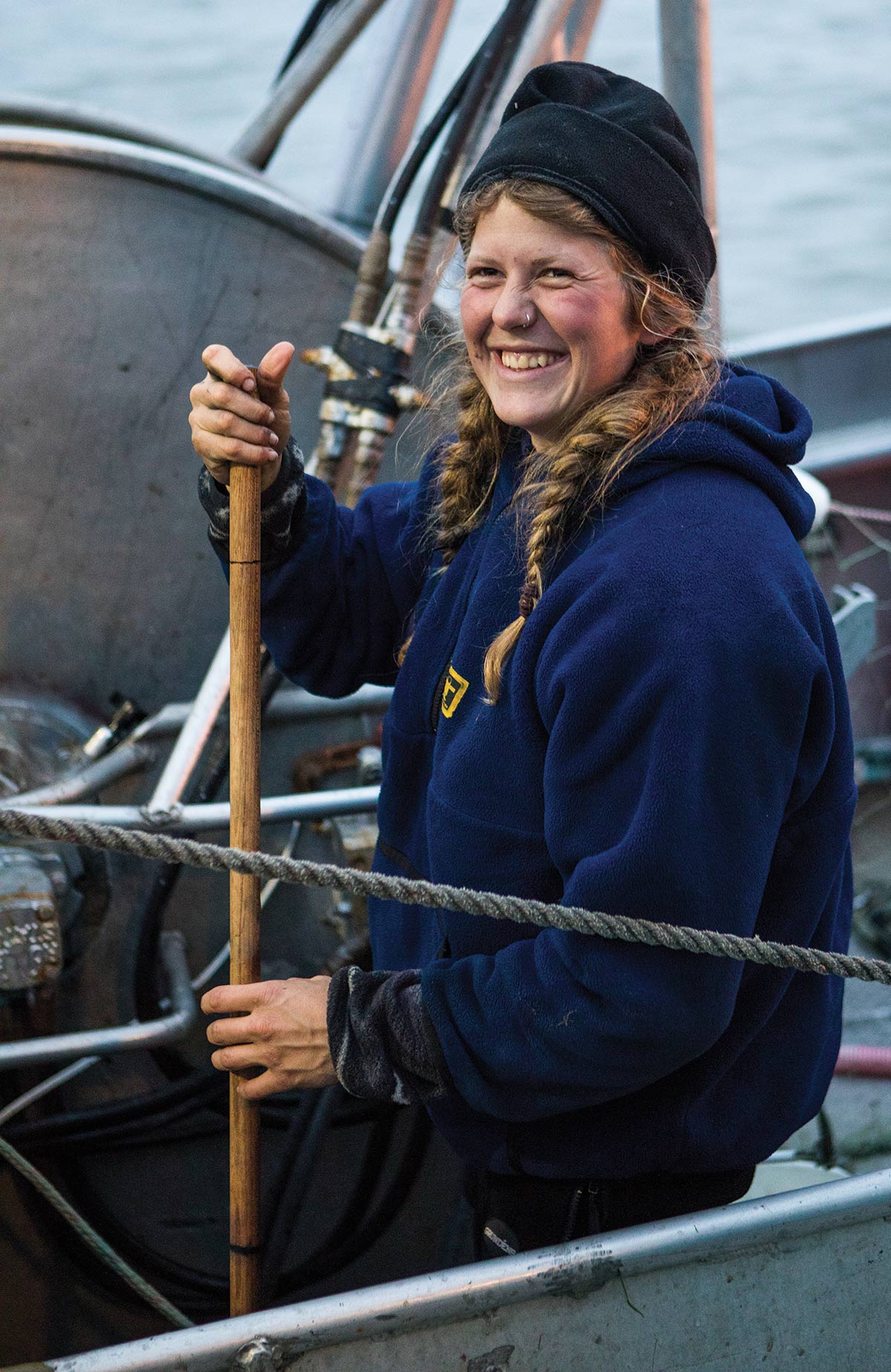 woman on a fishermen boat smiling