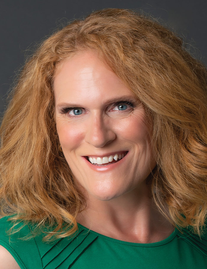 Story wearing green and smiling