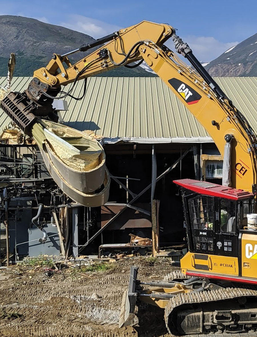 CAT construction machine picking up dirt on mountain