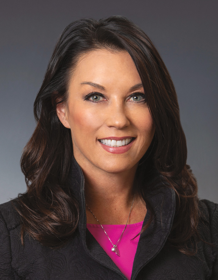 A headshot photograph of Julie Sande smiling (Commissioner of the Alaska Department of Commerce, Community, and Economic Development)