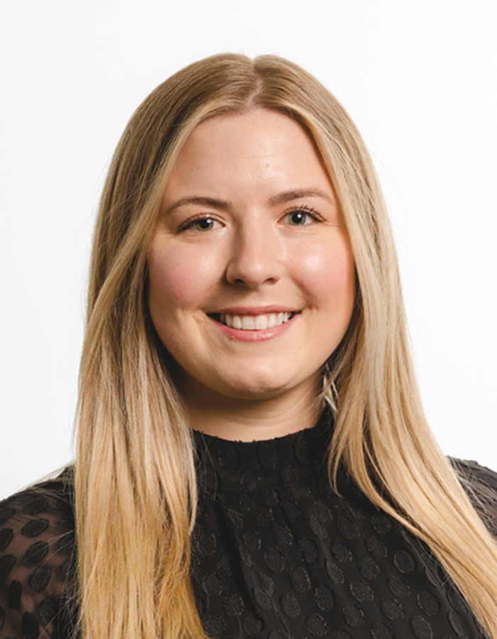 A headshot photograph of Taylor Sanders smiling (Web Manager at Alaska Business)