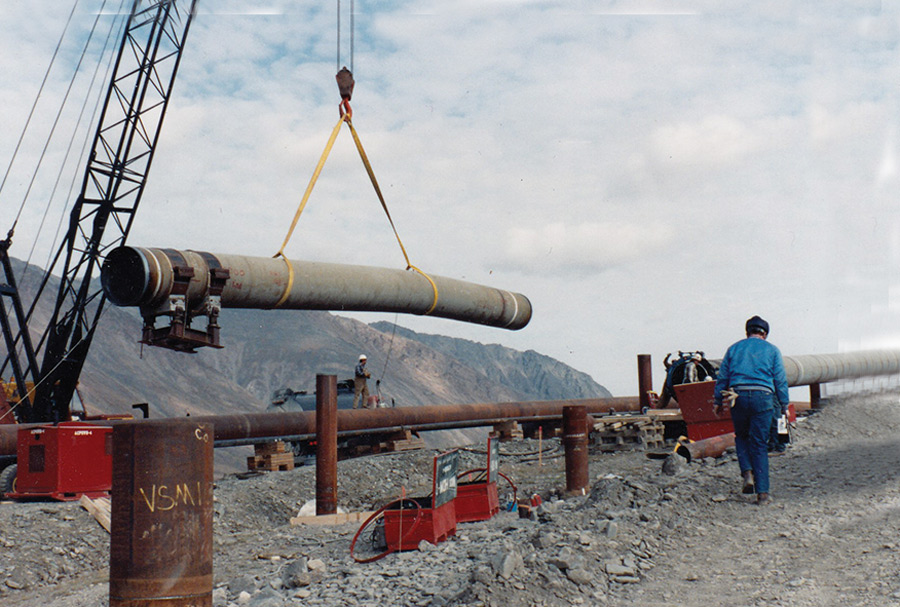 crane lifting a concrete tube