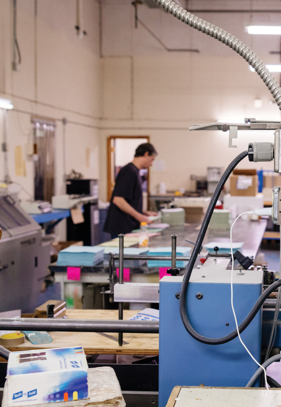 printing machine with man in background working