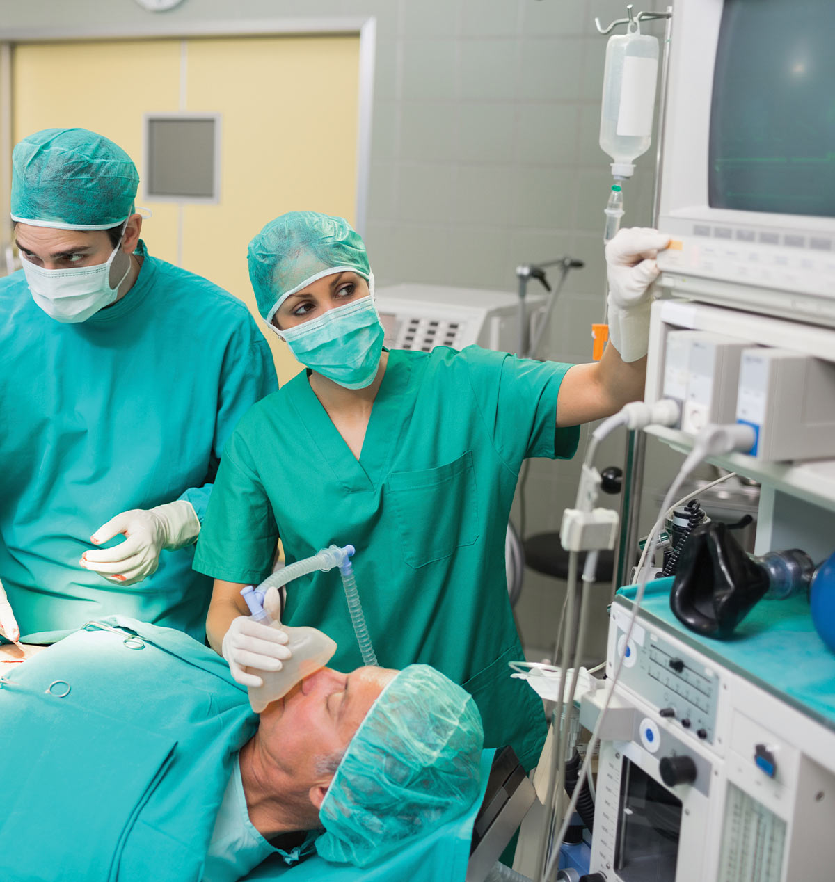 doctors and nurses during surgery with the focus on the anesthesiologist