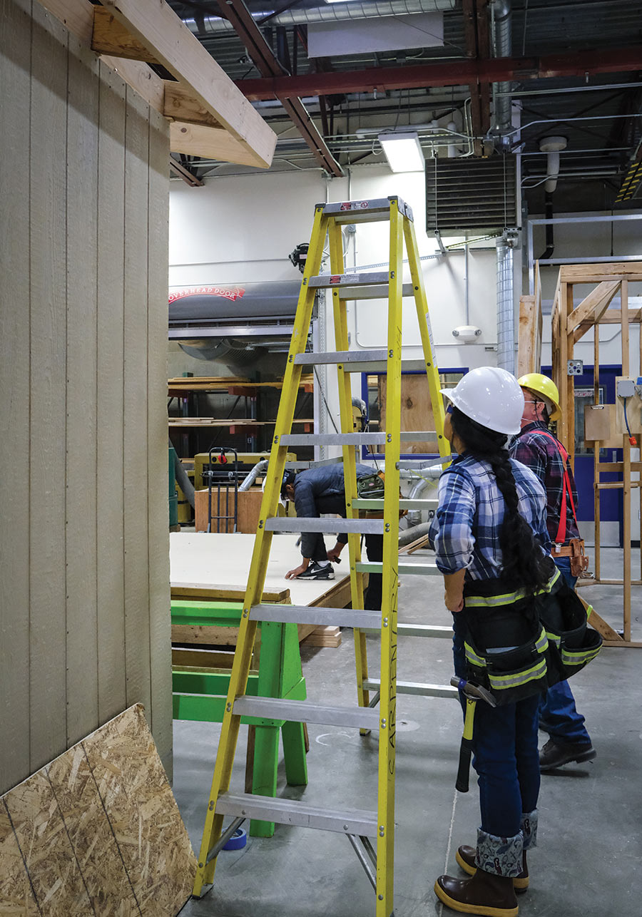 A King Tech student assesses the roof of a shed in a carpentry course