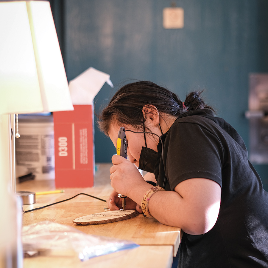 Students at Kusilvak Career Academy keep up with regular studies, such as wood burning for art class