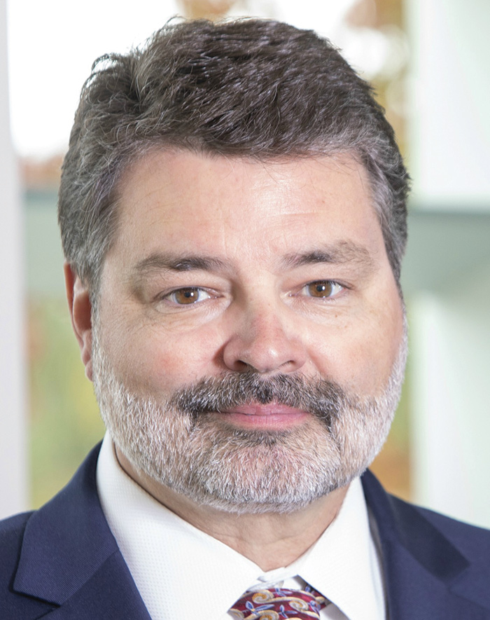 A photograph of Darren Franz grinning (Chief Credit Officer/Senior Executive Officer at First National Bank Alaska)