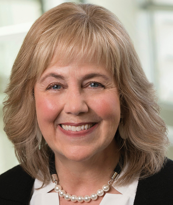 A photograph of Cheri Gillian smiling (Senior Executive Officer at First National Bank Alaska)