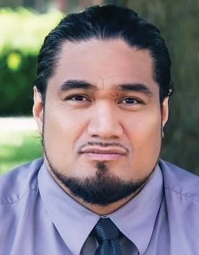 A headshot photograph of Uluao "Junior" Aumavae grinning (Municipality of Anchorage’s Chief Equity Officer)