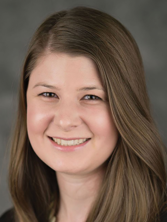 A headshot photograph of Katie Berry smiling (Director of Economics and Research at McKinley Research Group)