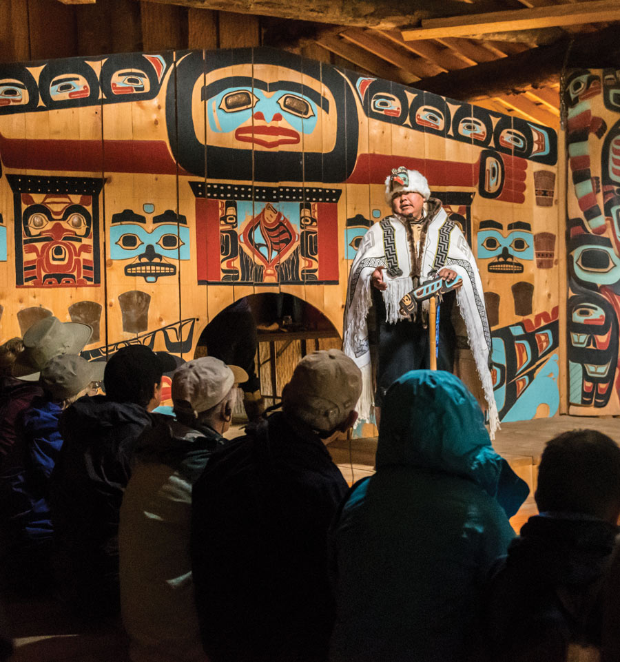 Cultural tourists enjoy a presentation on Tlingit heritage at the Jilkaat Kwaan Heritage Center at Klukwan
