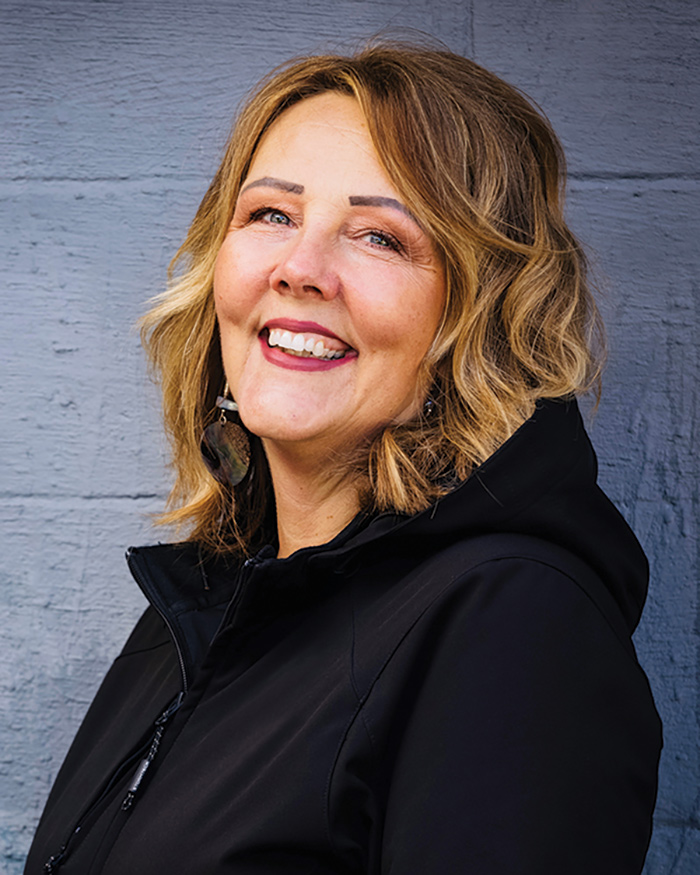 A headshot portrait photograph of Dawn Wesley smiling