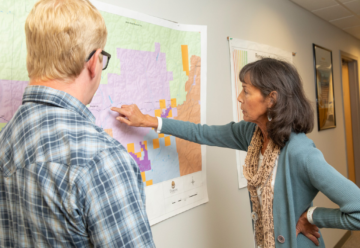 woman pointing at map showing man