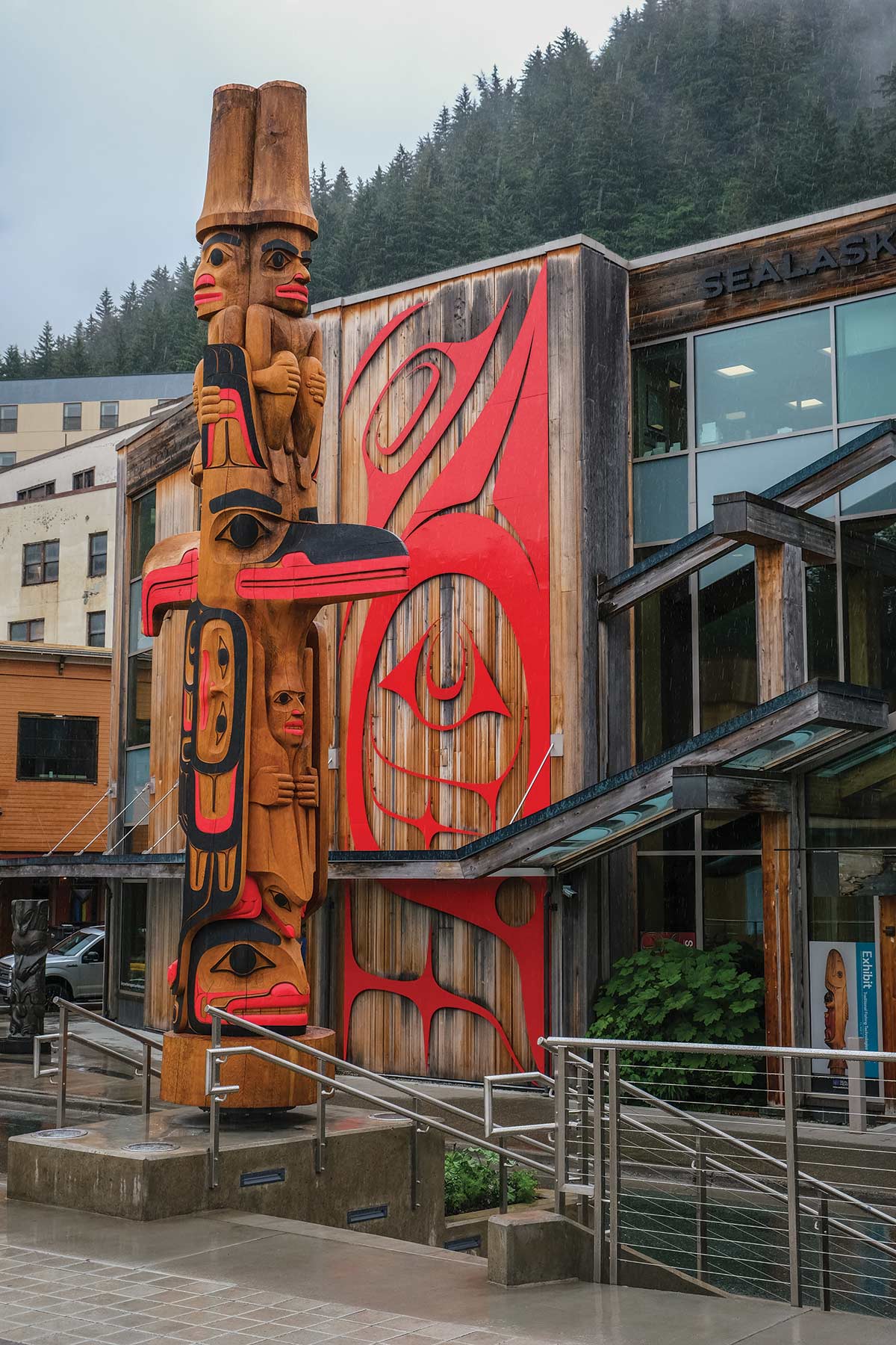 Raven and Eagle stand back to back on Alaska’s first 360-degree totem pole