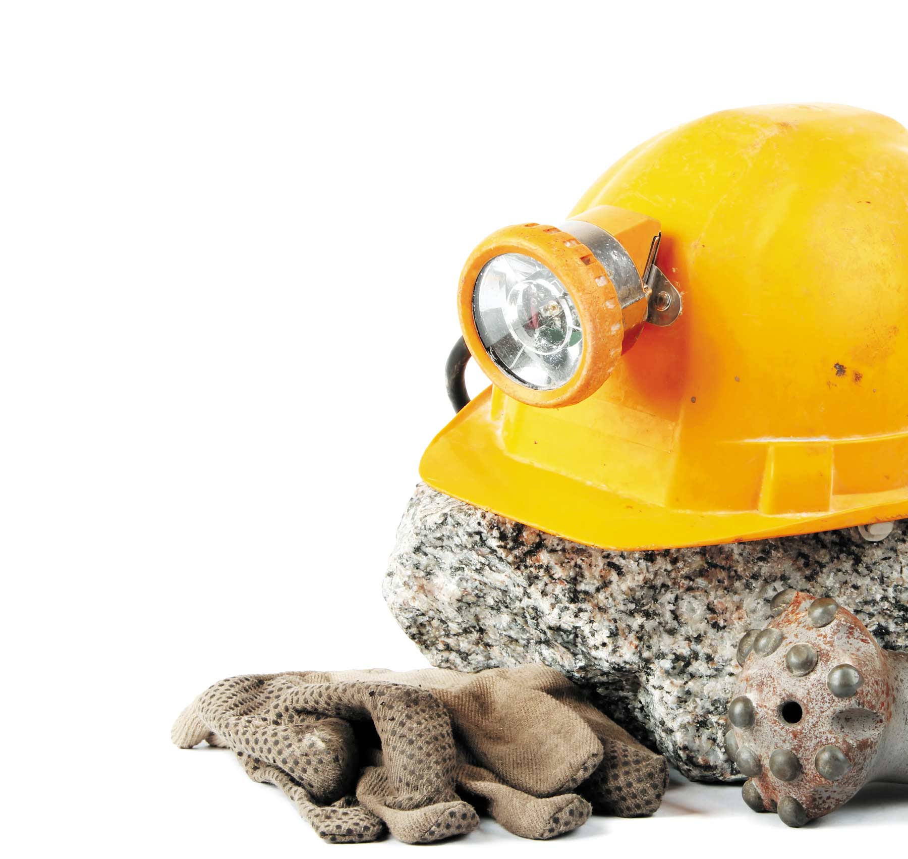 Miner's helmet sitting on a rock, gloves 