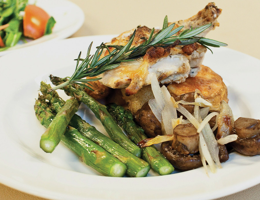 chicken dish with mushroom and asparagus topped with rosemary
