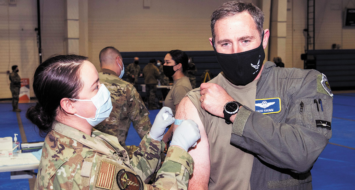 Hecla’s Greens Creek Mine, Northern Star Resources’ Pogo Mine, and Coeur’s Kensington Mine are all underground mines in Alaska A landscape photograph of a woman dressed in her military outfit giving a COVID-19 vaccine shot in the right side arm of a man dressed in his military outfit