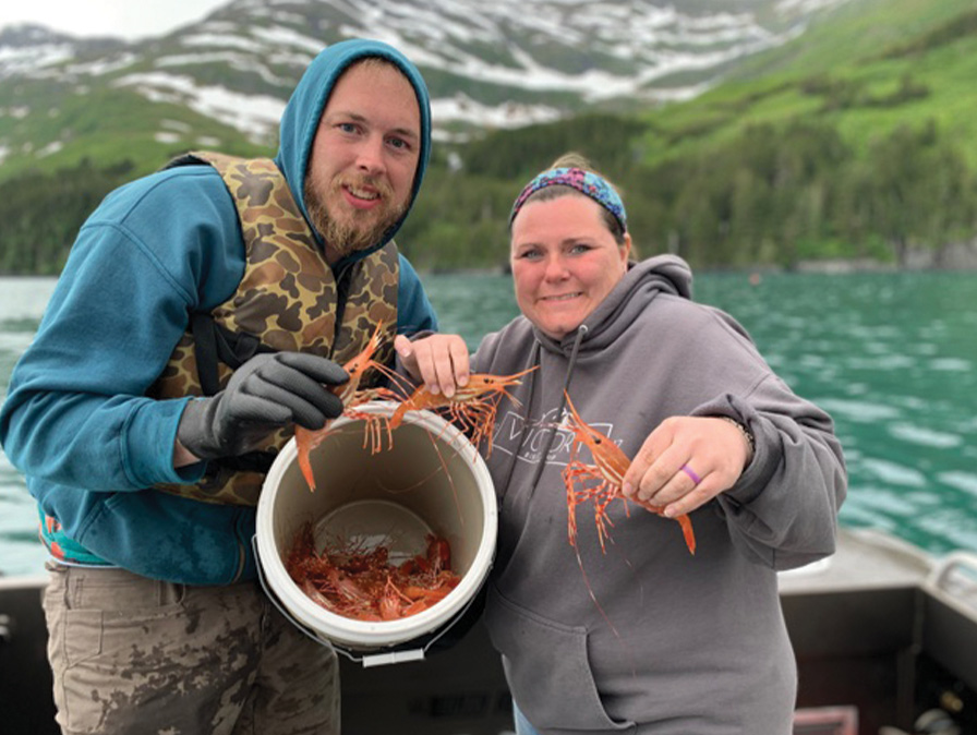 Family with a bucket of red crawdads on a boat