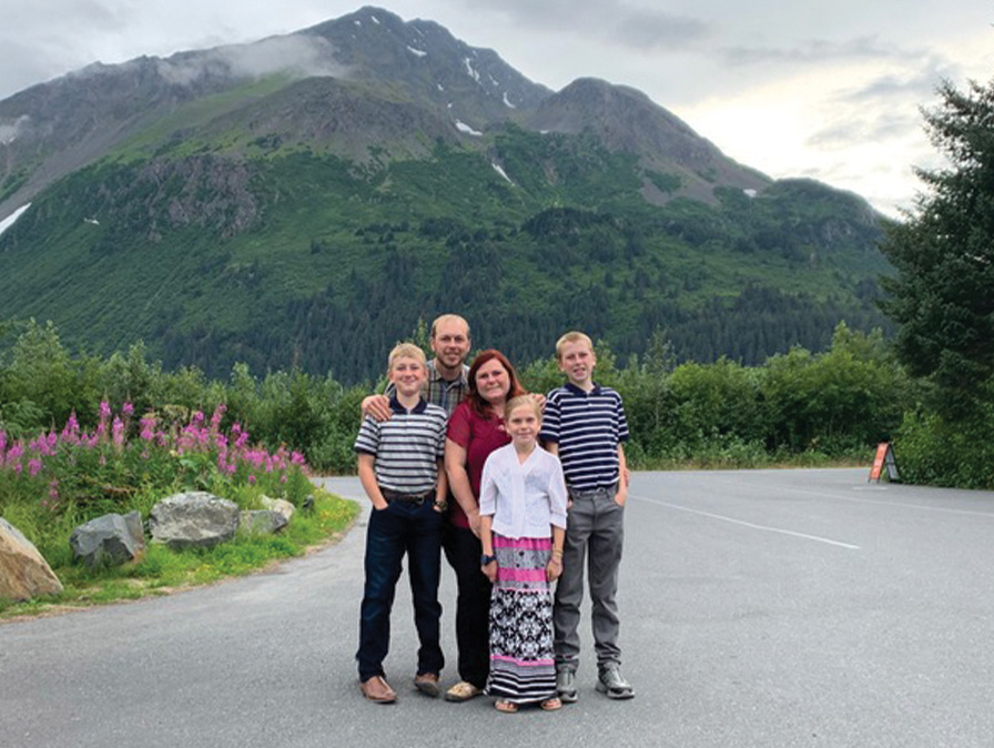 Family photo against a backdrop of mountains