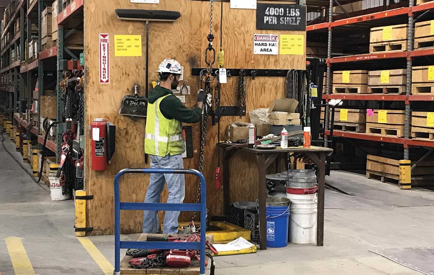 a man does work in an industrial storage space