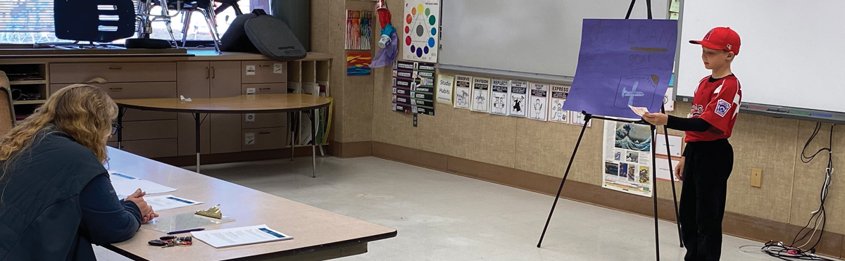 kid giving presentation of business to class