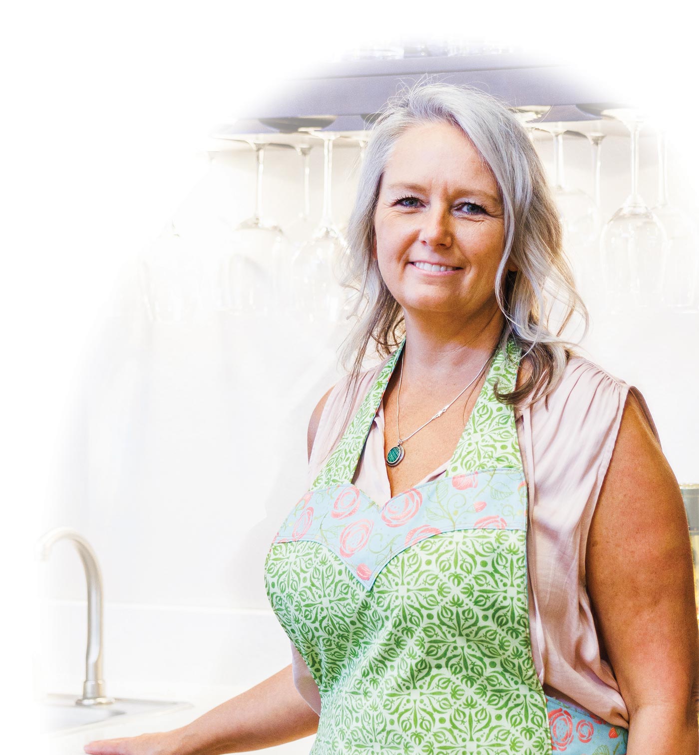 Amie Sommer in green floral patterned apron