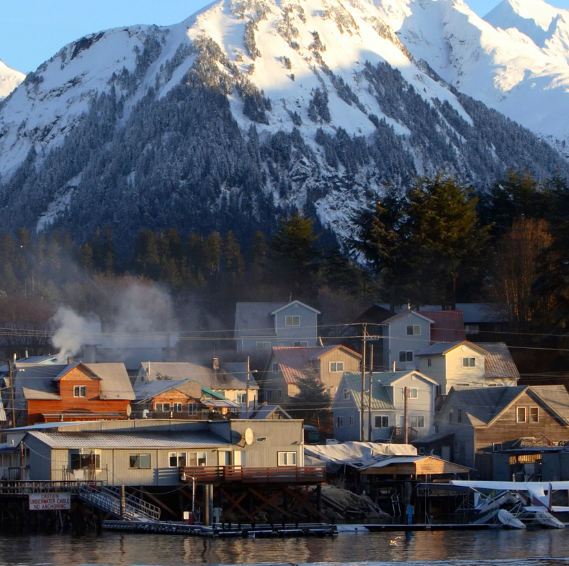 Snowy mountain in distance with houses in front
