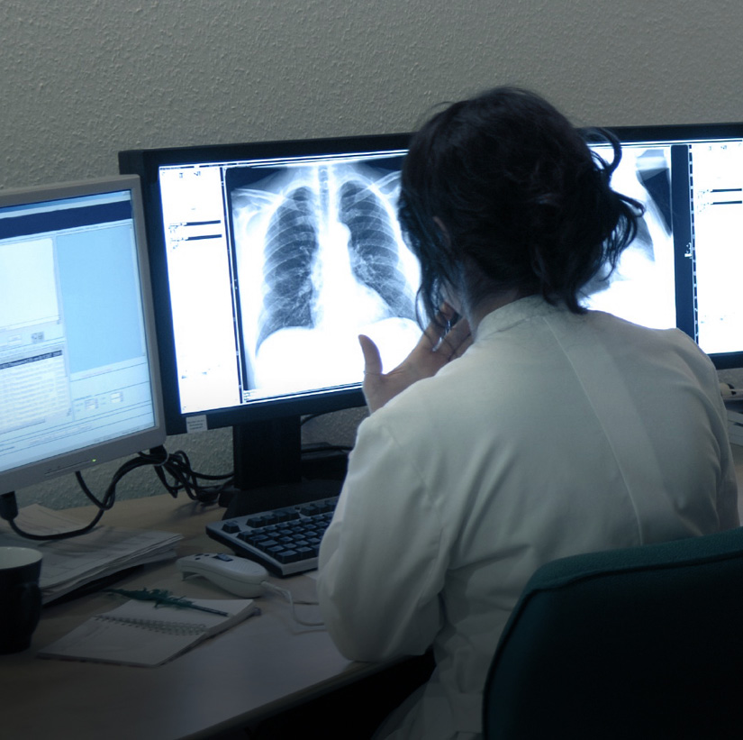 Woman on computer looking at xrays