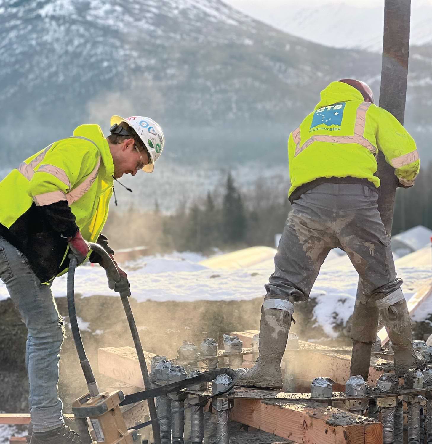 two STG Incorporated construction workers on a job