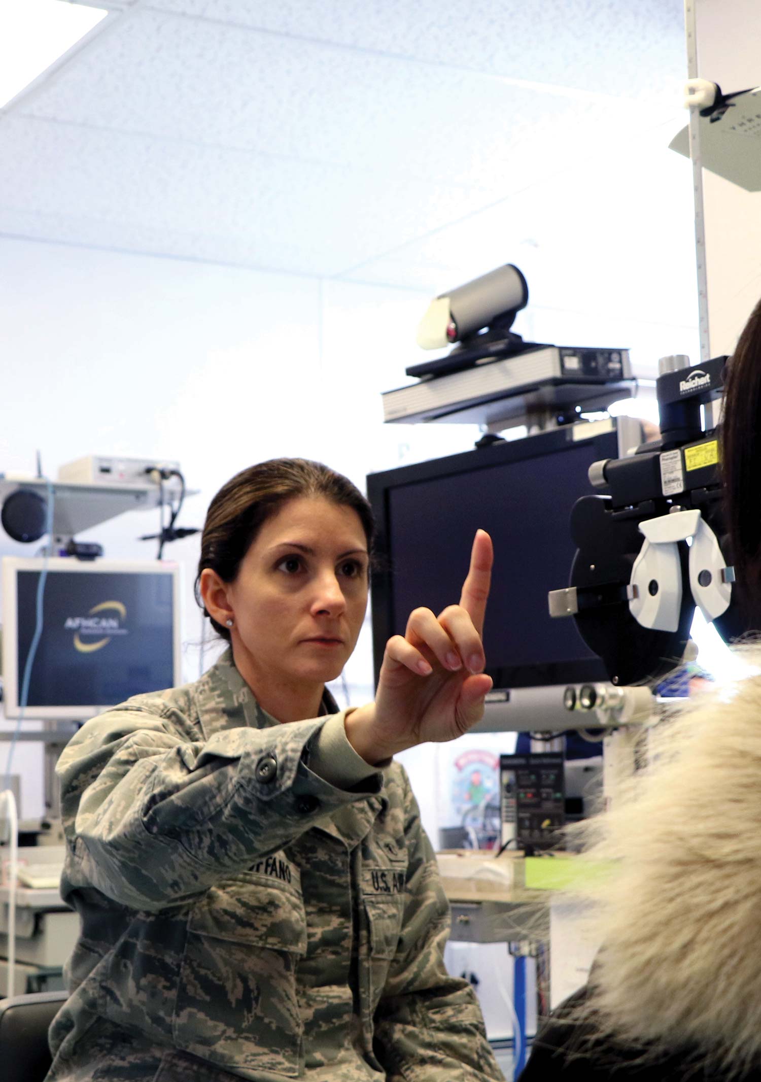 military member conducting a vision test