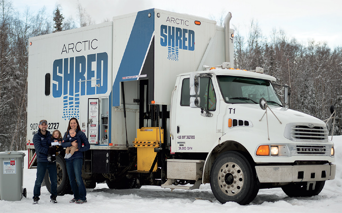 Johanna and Steven Rupp, creators of Arctic Shred holding their children outside of their Arctic Shred work truck