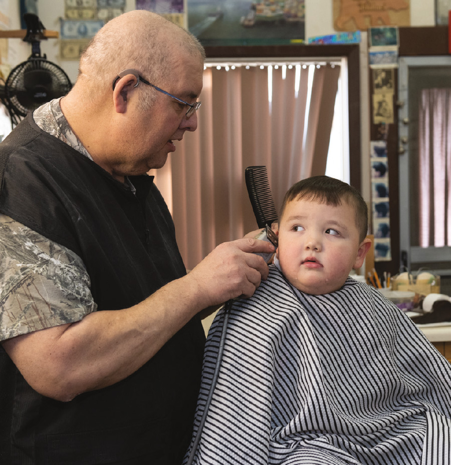 Atticus Kinegak gets a haircut from Stan.