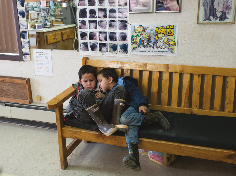 two children sitting on bench in waiting room
