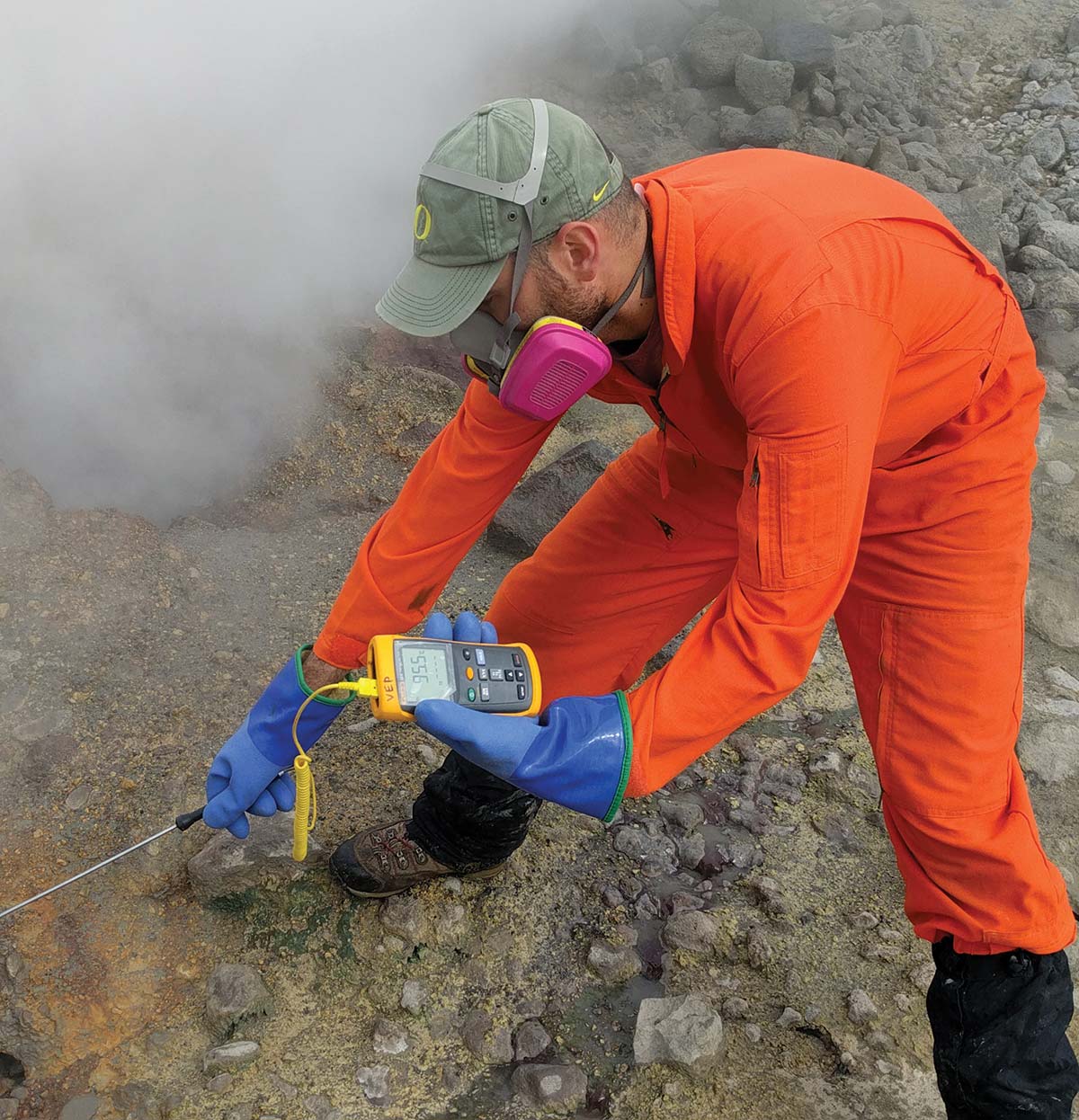 Geochemist Allan Lerner of the US Geological Survey measures the temperature of a bubbling pool in the upper Glacier Valley south of Makushin Volcano.