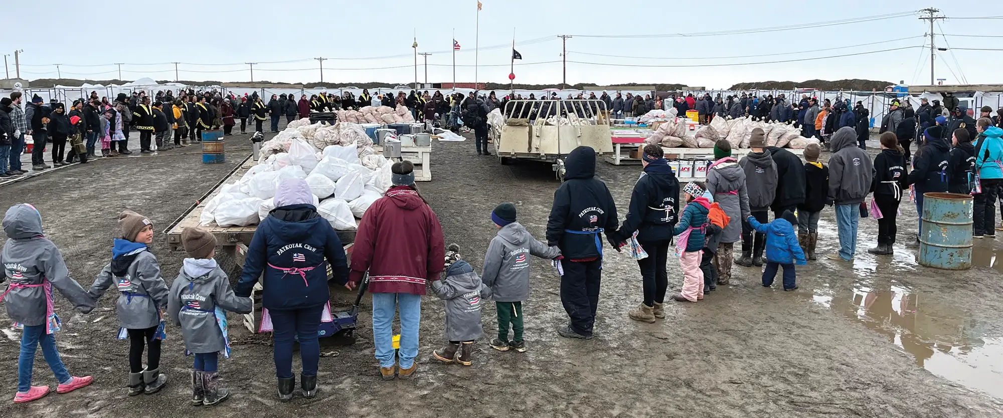 Group of people standing in a large circle holding hands