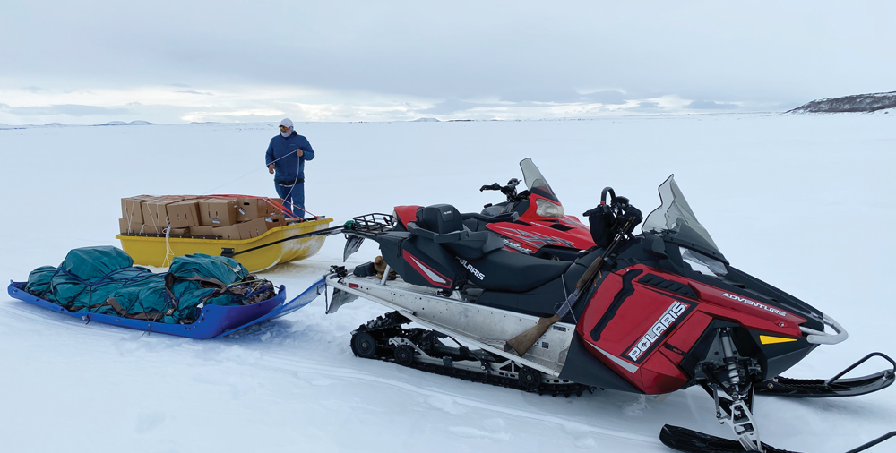snowmobile in the snow carrying packages